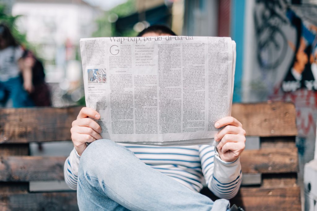 a woman reading a newspaper